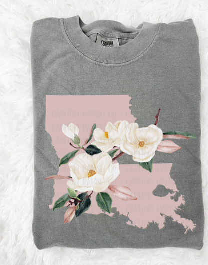 Folded gray sweatshirt with a floral design on a white background