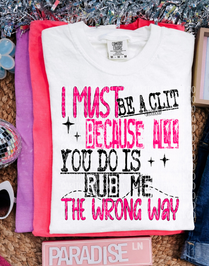 White t-shirt with humorous text design on a textured surface.
