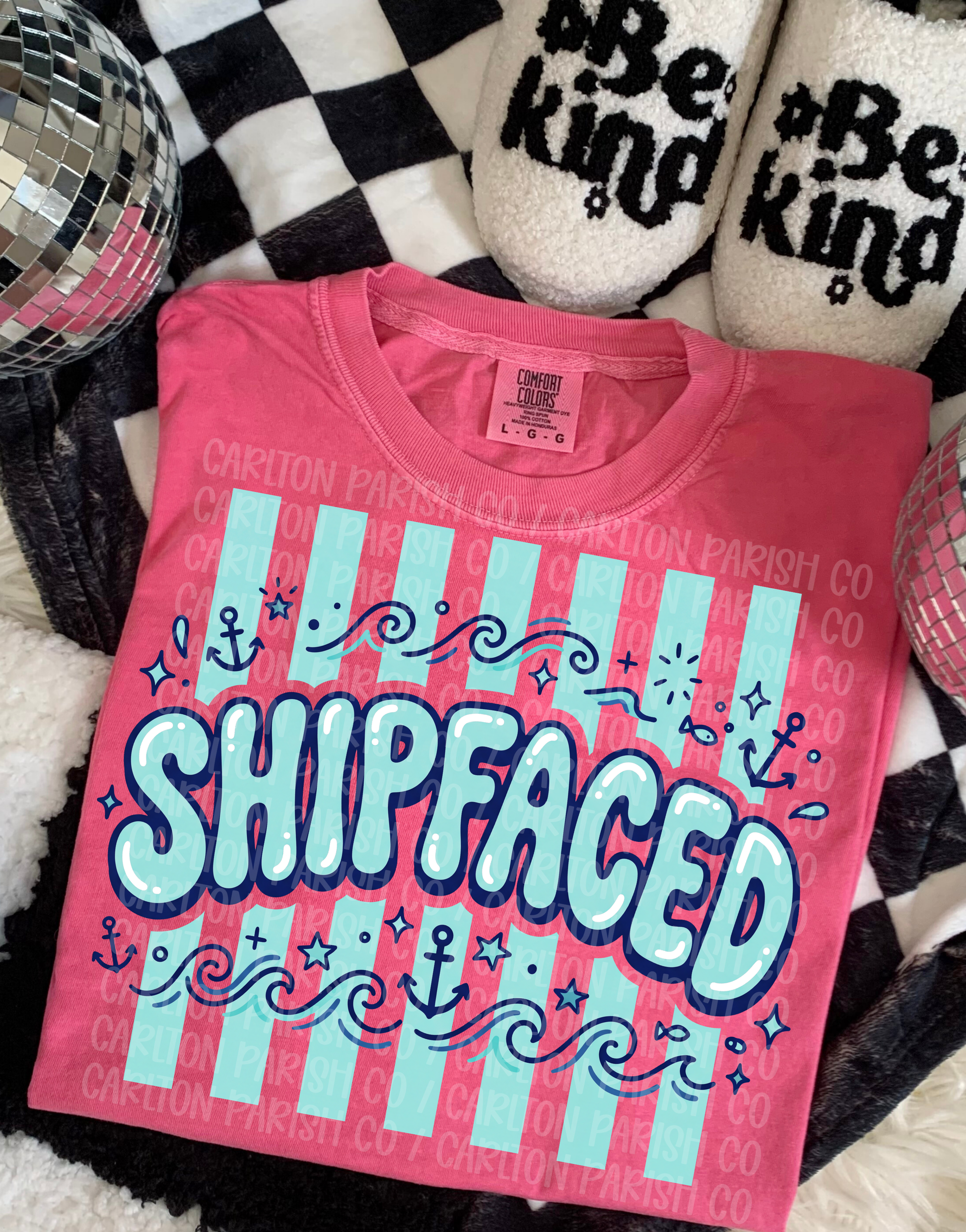 Pink t-shirt with 'SHIPFACED' text on a checkered background
