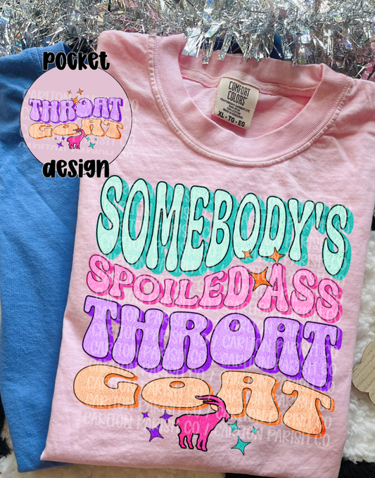 Pink t-shirt with colorful text design on a hanger